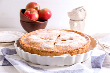 Plate with delicious apple pie on table