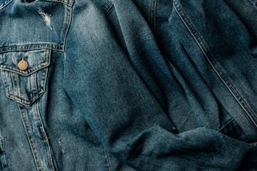 Naklejka premium top view of denim jacket as background
