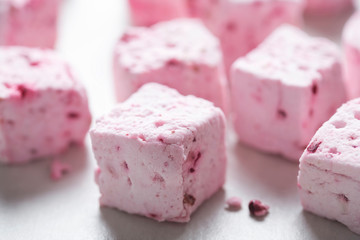 Marshmallows with cherries and raspberries. 
