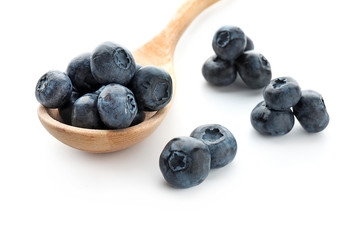 Spoon with ripe blueberries on white background