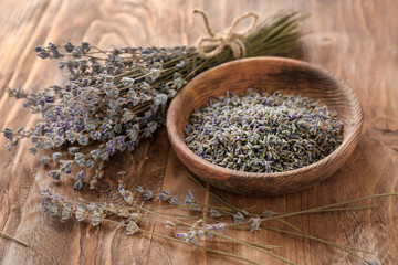 Bowl with lavender flowers on wooden table