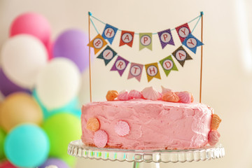 Beautiful tasty birthday cake on dessert stand