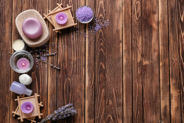Spa composition with candles, sea salt and lavender on wooden background