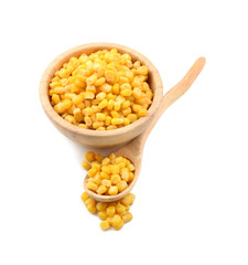 Bowl and spoon with tasty corn kernels on white background
