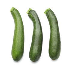 Ripe zucchinis on white background