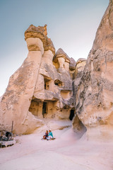 happy young couple on vacation in Turkey Cappadocia, Rock Formations in Pasabag Monks Valley, Cappadocia, Turkey - obrazy, fototapety, plakaty