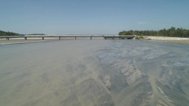 Modern bridge over river with cars in a mountain province Philippines,Luzon. Aerial view Bucao Bridge.