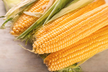 Fresh corn cobs on table, closeup