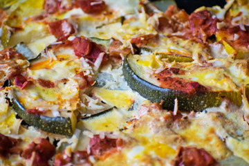 Casserole with zucchini, tomatoes and eggs on a baking sheet. Juicy casserole with courgettes.