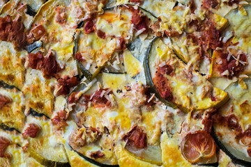 Casserole with zucchini, tomatoes and eggs on a baking sheet. Juicy casserole with courgettes.