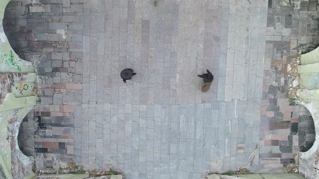 Aerial shooting, two men converge in the middle of the yard and start a duel