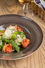 Red fish healthy salad with mixed lettuce leaves