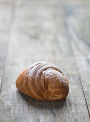 Bun with jam on old wooden background