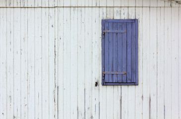 Purple Window Shutter on a Wooden Exterior Wall