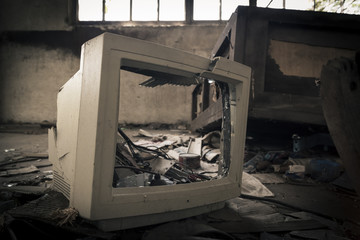 Broken computer monitor in abandoned factory.