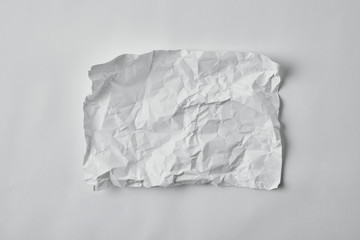 top view of blank crumpled paper on white surface