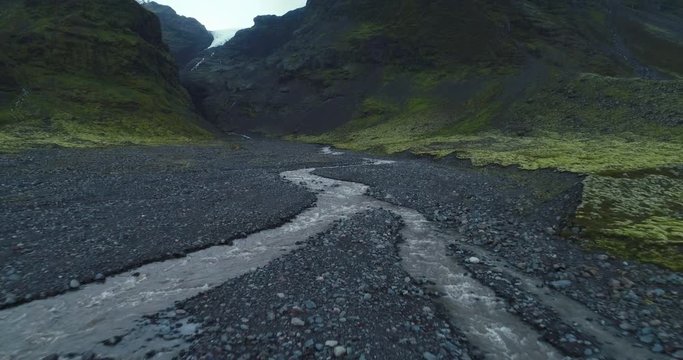 Aerial slow motion view of calm serine valley with rivers and mountains