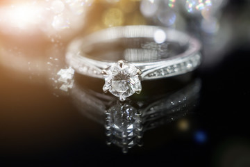 Naklejka na ściany i meble Jewelry diamond rings with reflection on black background
