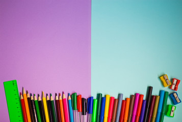  Back to school background. Top view of school supplies on purple and blue background
