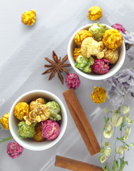 Beautifully decorated multi-colored popcorn with cinnamon and herbs Popcorn on top.