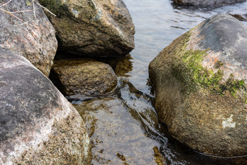 Naklejka na ściany i meble Rocks on the shore of a lake