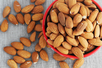 A ceramic bowl full of almonds