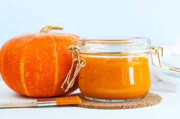 Homemade pumpkin face mask in a glass jar. DIY cosmetics and spa. Copy space.