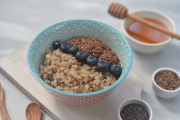 Buckwheat porridge in a bowl with flax seeds and blueberries. oncept healthy food, detox, diet, breakfast