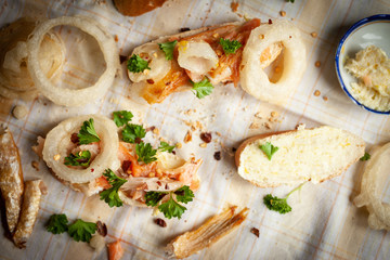 Smoked fish sandwich with onion rings