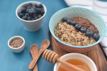 Buckwheat porridge in a bowl with flax seeds and blueberries. oncept healthy food, detox, diet, breakfast
