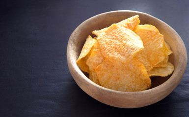 Potato chips on table background