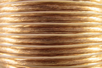 Selective focus, closeup of golden coiled speaker wire