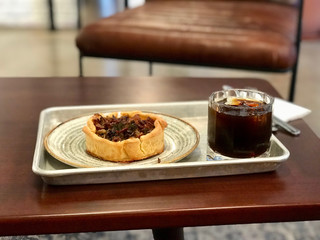 Homemade Vegetable Quiche Tart with Seasonings and Cold Brew Coffee at Cafe Shop / Restaurant