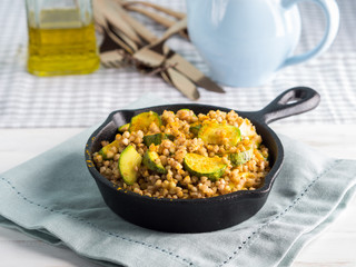 Buckwheat with zucchini and turmeric in cast iron skillet. Easy and healthy lunch for celiac gluten free diet