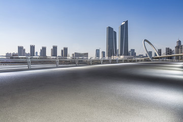 Obraz premium Panoramic skyline and modern business office buildings with empty road,empty concrete square floor