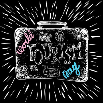 World Tourism Day. 27 September. A suitcase with stickers and the name of the holiday. Hand drawing, lettering