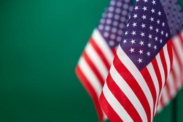 Obraz premium Flags United States of America with green background empty space for your text on left.