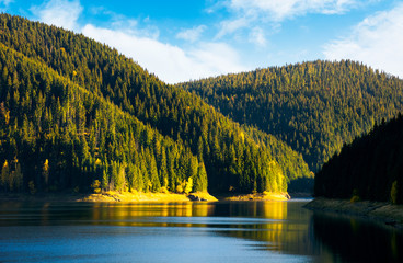 storage reservoir in mountain at sunrise. beautiful  landscape in early autumn