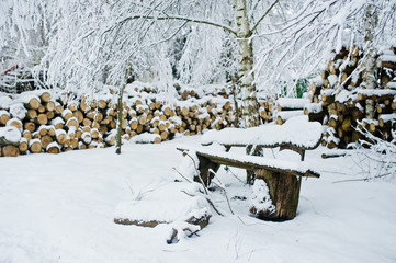Stack of wood chunks covered with snow. Winter.