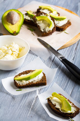 sandwich bread rye cheese curd avocado dill  wooden  background