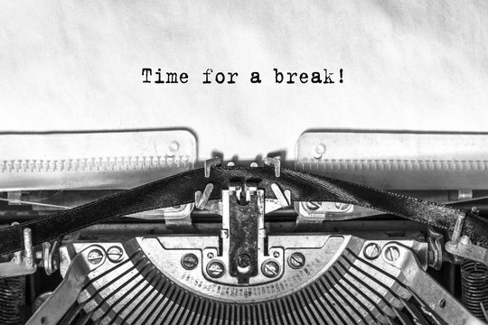Time for a break, typed text on an old typewriter, close-up, ink on paper