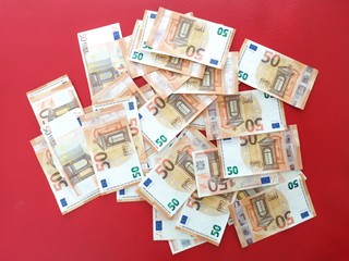 European money fifty euro bills on red carpet, euro money overflowing background, euro bank notes