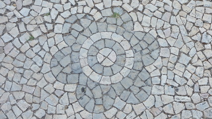 Gray street tiles arranged in a flower pattern