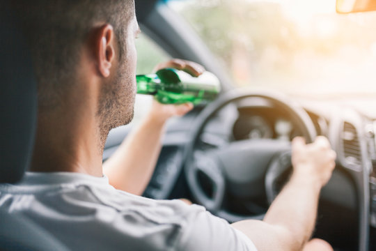 Drunk driver behind the steering wheel of a car