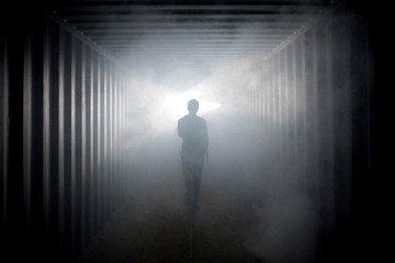 Light at the end of the tunnel. Silhouette of people in dark passage - Powered by Adobe