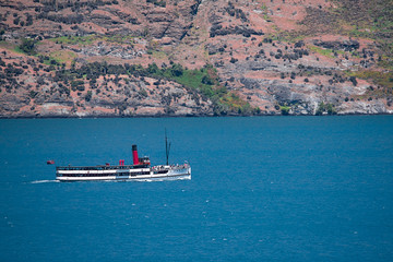 Obraz premium old style fashion ferry cruise boat sailing in the canel river carry passenger tourist sightseeing scenery view along the river and hilld mountain