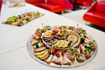 Close-up photo of salty snacks made with meat on the table.