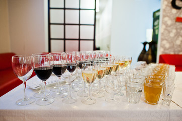 Different alcohol beverages in glasses on the table in restaurant or bar.