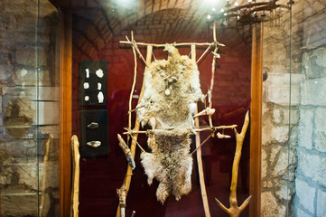 Clothing and some tools or weapons of a primitive man.