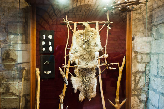 Clothing and some tools or weapons of a primitive man.